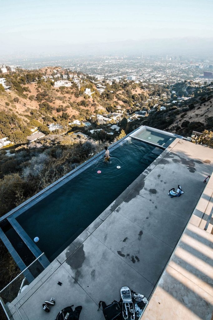 person in infinity pool during daytime